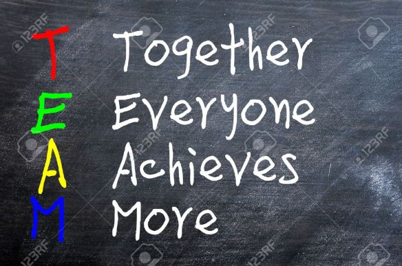 14041415-TEAM-acronym-for-Together-Everyone-Achieves-More-written-on-a-smudged-blackboard-Stock-Photo